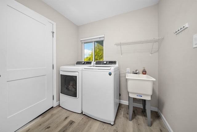 155 Aliilani Pl, Kihei, HI 96753 - washroom featuring washer and dryer, light wood-style flooring, and baseboards
