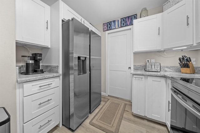 155 Aliilani Pl, Kihei, HI 96753 - kitchen featuring stainless steel appliances, light wood-style floors, white cabinetry, and light stone counters