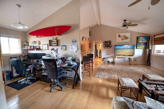 home office with vaulted ceiling with beams, a wealth of natural light, and light hardwood / wood-style flooring