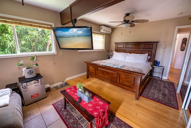 bedroom with lofted ceiling with beams, a wall mounted AC, ceiling fan, and light tile patterned floors