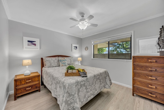 bedroom featuring crown molding, light wood-style flooring, baseboards, and ceiling fan