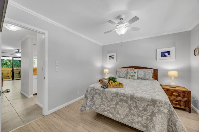bedroom with ceiling fan, ornamental molding, baseboards, and light wood-type flooring