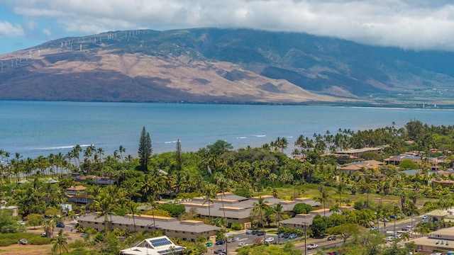 drone / aerial view featuring a water and mountain view