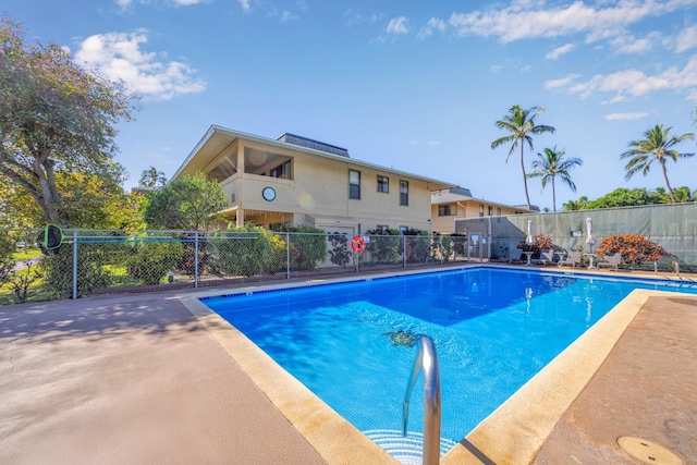 view of pool with a fenced in pool and fence