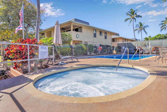pool featuring ceiling fan, fence, a community hot tub, and a patio area