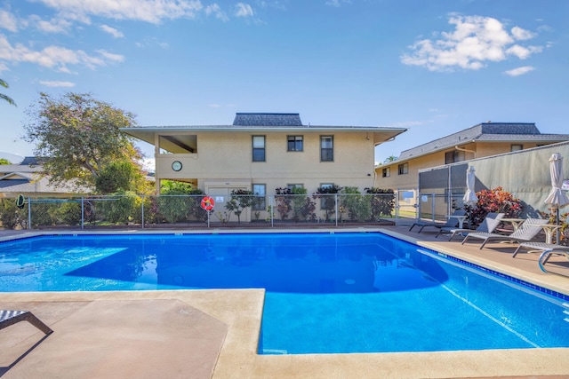 view of swimming pool featuring fence, a fenced in pool, and a patio