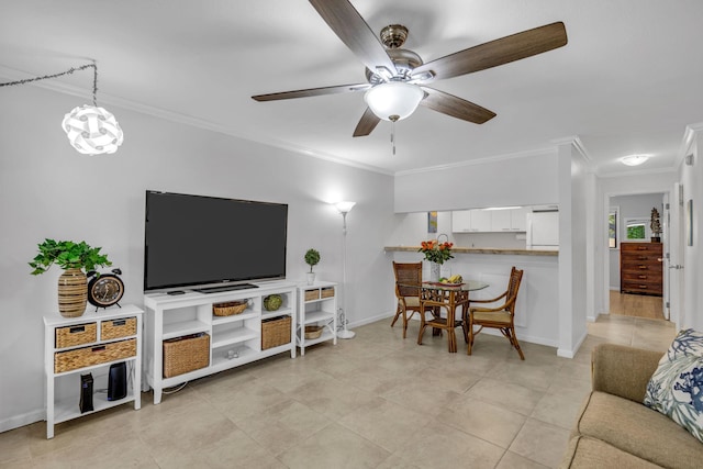 living room featuring ceiling fan, baseboards, light tile patterned flooring, and ornamental molding
