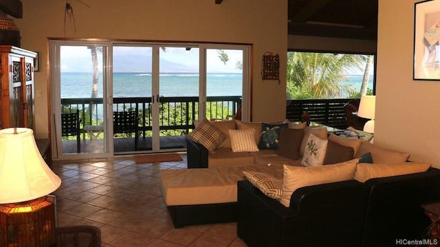 living room with tile patterned floors and a water view