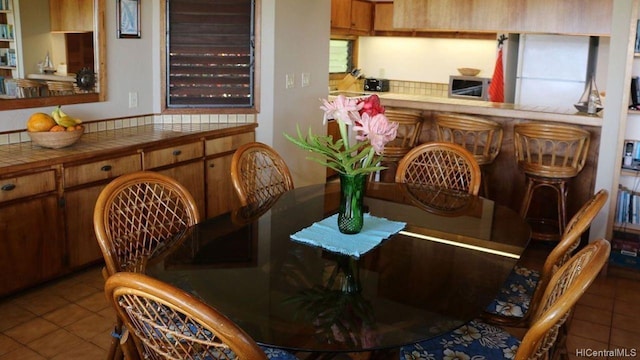 dining space featuring light tile patterned flooring