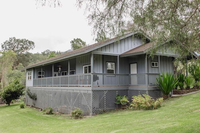 exterior space with a porch, board and batten siding, and a front lawn