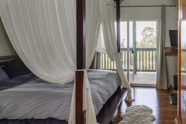 bedroom featuring access to outside and wood finished floors