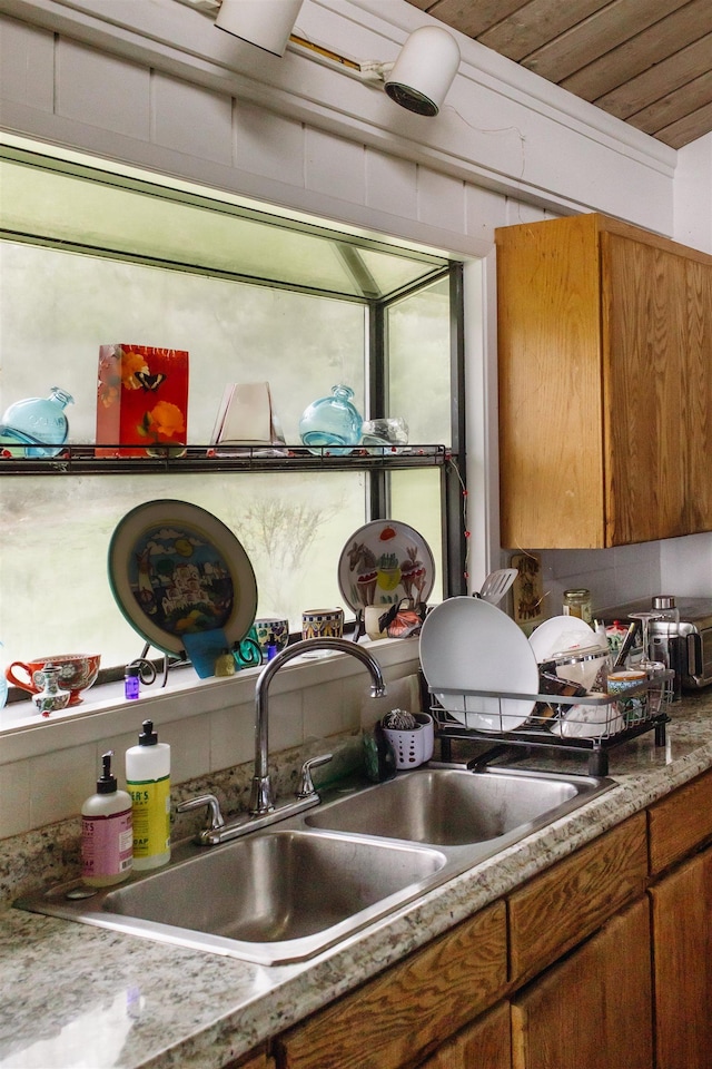details featuring brown cabinetry and a sink