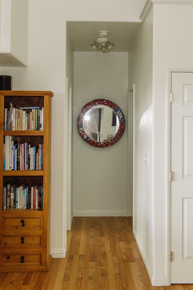 hallway with baseboards and wood finished floors