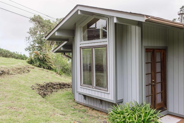 view of side of home featuring a lawn