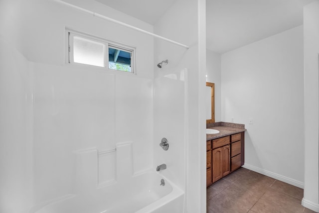full bath with vanity, baseboards, tile patterned flooring, and bathing tub / shower combination