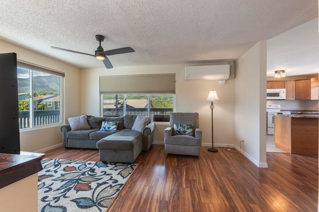 885 Haunani Pl, Wailuku, HI 96793 - living room with dark wood-type flooring, ceiling fan, a healthy amount of sunlight, and a wall unit AC