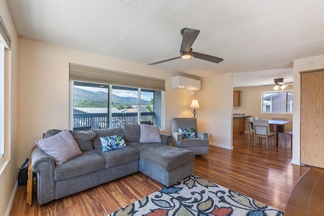 885 Haunani Pl, Wailuku, HI 96793 - living area with a textured ceiling, a wall mounted AC, wood finished floors, and a ceiling fan