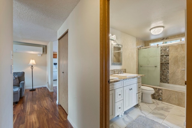 885 Haunani Pl, Wailuku, HI 96793 - bathroom with a wall mounted air conditioner, toilet, a textured ceiling, vanity, and tiled shower / bath combo