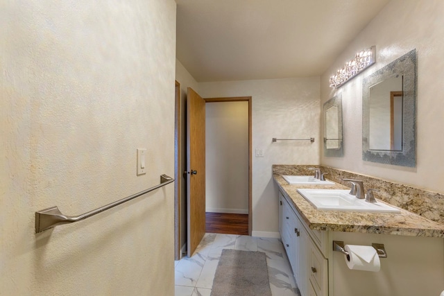 885 Haunani Pl, Wailuku, HI 96793 - bathroom with a sink, baseboards, double vanity, and marble finish floor