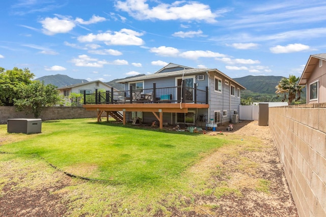 885 Haunani Pl, Wailuku, HI 96793 - rear view of house with a fenced backyard, a deck with mountain view, a lawn, and stairs