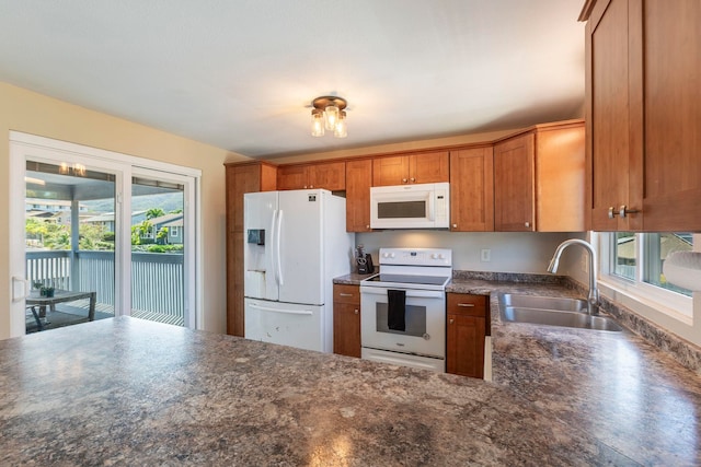 885 Haunani Pl, Wailuku, HI 96793 - kitchen featuring brown cabinetry, a sink, white appliances, and dark countertops