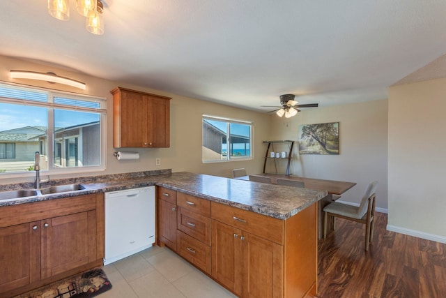 885 Haunani Pl, Wailuku, HI 96793 - kitchen with ceiling fan, brown cabinetry, a peninsula, dishwasher, and a sink