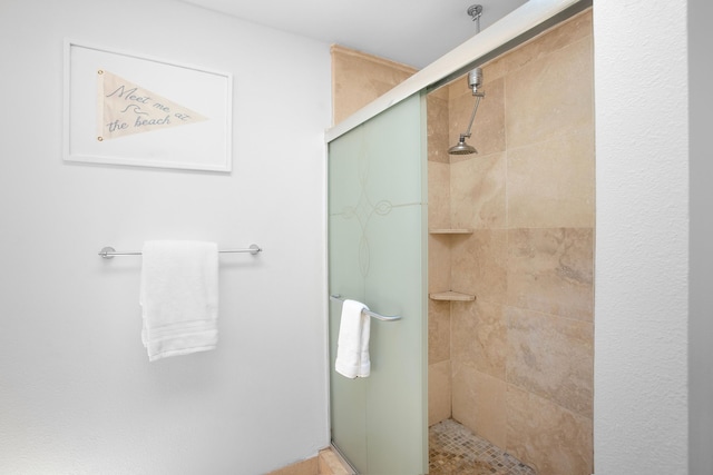 bathroom with a shower with shower door