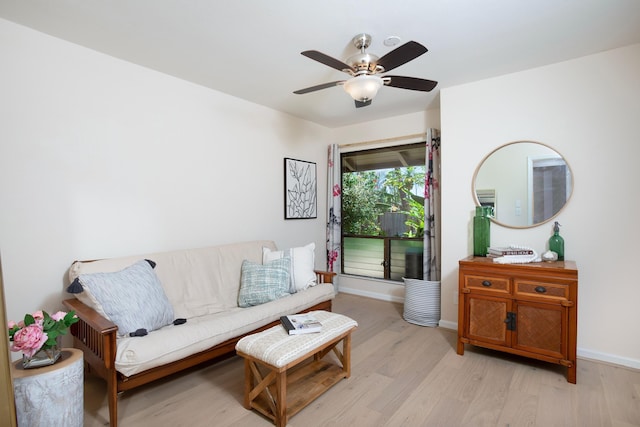 living room with ceiling fan and light wood-type flooring