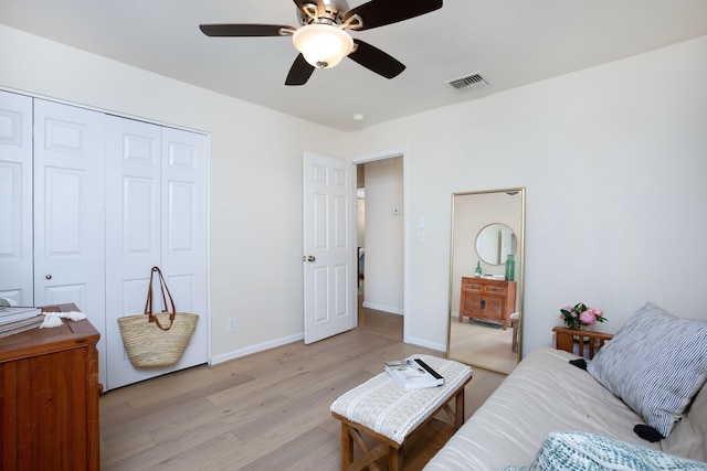 living room with ceiling fan and light hardwood / wood-style floors