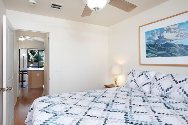 bedroom with ceiling fan and wood-type flooring