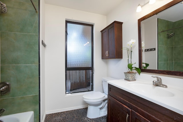 full bathroom featuring vanity, tiled shower / bath combo, and toilet