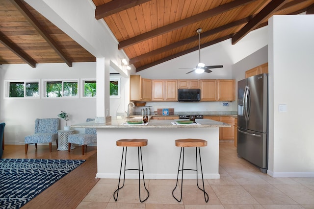 kitchen featuring light stone countertops, stainless steel fridge with ice dispenser, high vaulted ceiling, kitchen peninsula, and a kitchen bar