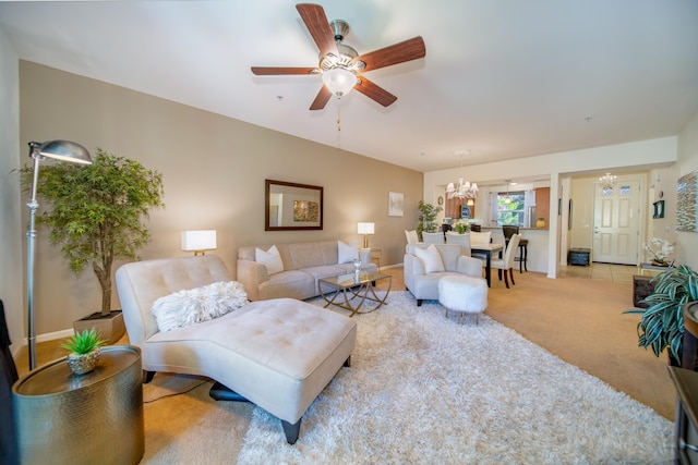 18 Upena Ln Unit E-102, Kihei, HI 96753 - living room featuring a chandelier, a ceiling fan, carpet floors, and baseboards