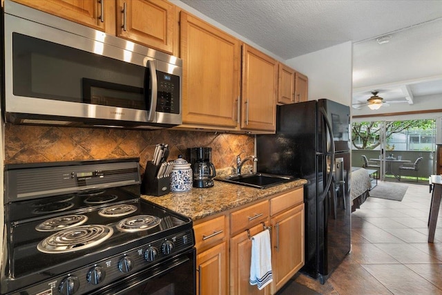 kitchen with stove, ceiling fan, tasteful backsplash, tile flooring, and beam ceiling