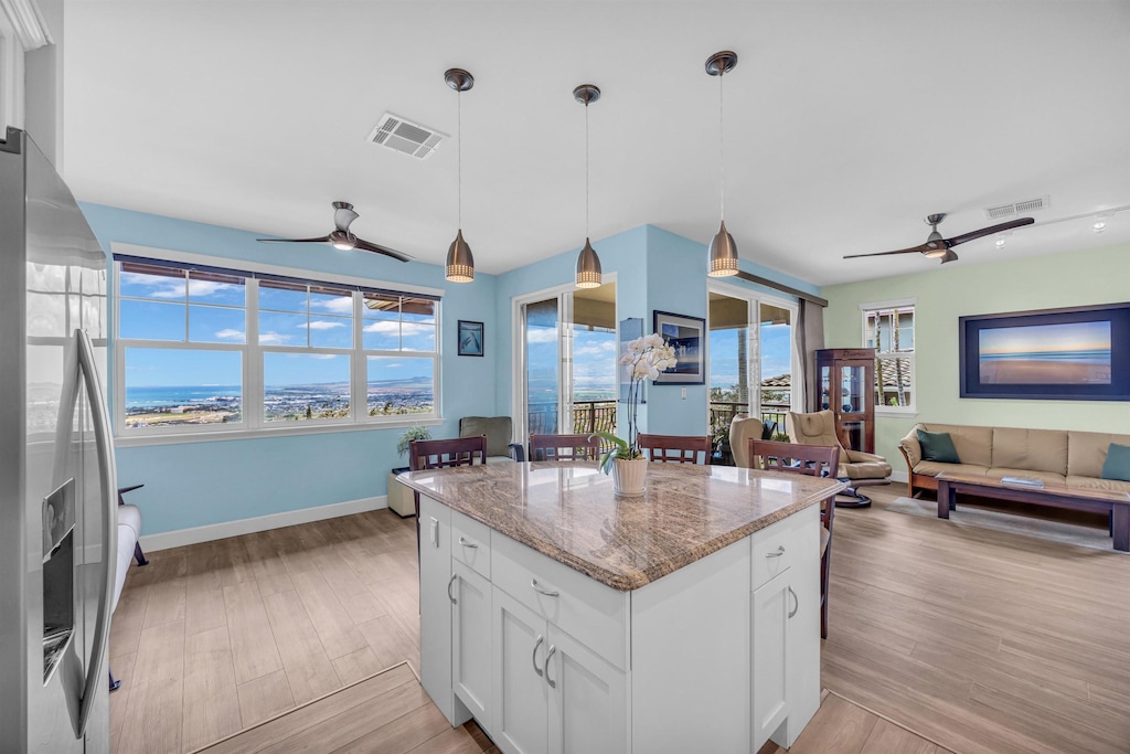 kitchen featuring visible vents, stainless steel fridge, and a ceiling fan