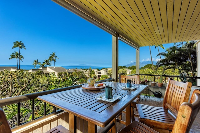 balcony with outdoor dining space and a mountain view