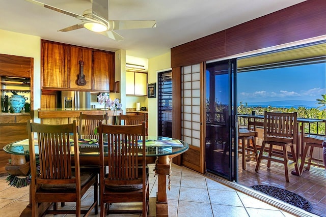 dining area with light tile patterned floors and a ceiling fan