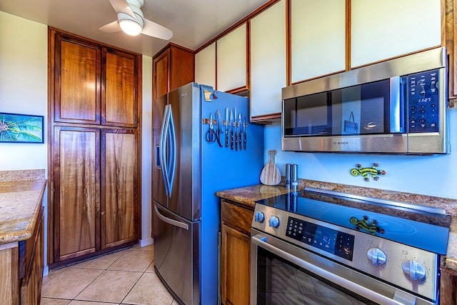 kitchen featuring mail area, appliances with stainless steel finishes, a ceiling fan, and light tile patterned flooring