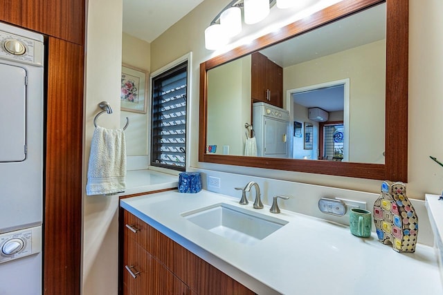 bathroom featuring stacked washer and dryer, vanity, and a wall mounted air conditioner