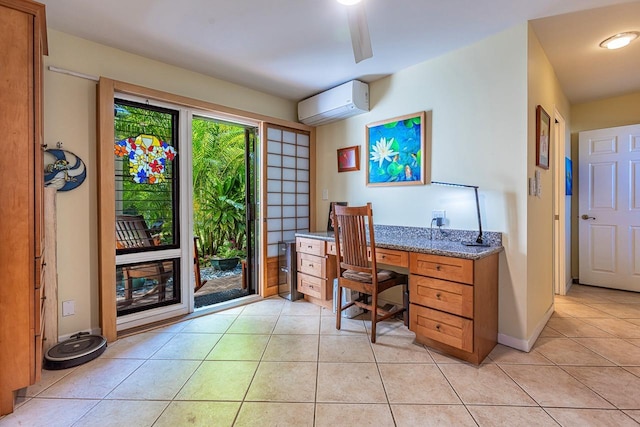 office featuring a wall unit AC, baseboards, and light tile patterned floors