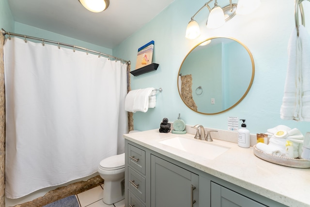 bathroom featuring toilet, vanity, and tile patterned floors