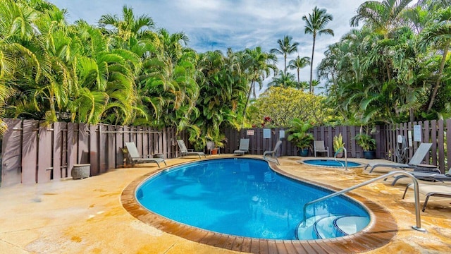 view of swimming pool with an in ground hot tub and a patio area