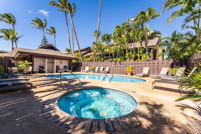 view of pool featuring a patio and a hot tub