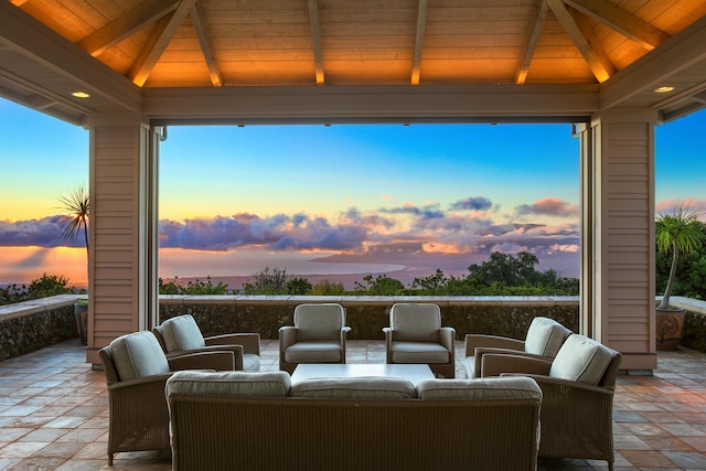 patio terrace at dusk featuring a gazebo and an outdoor living space