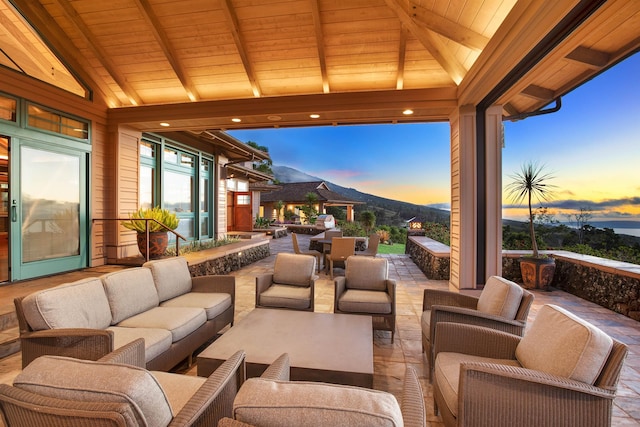 patio terrace at dusk featuring an outdoor hangout area