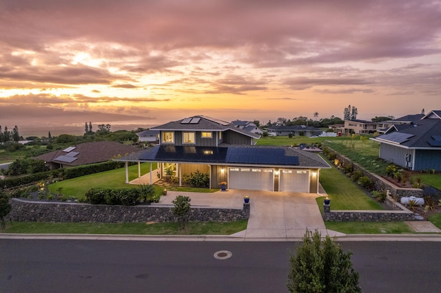 view of front of home featuring a lawn and solar panels