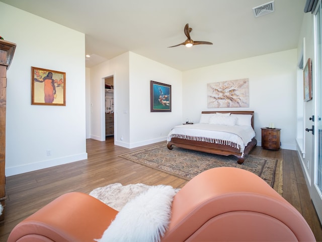 bedroom with dark hardwood / wood-style floors and ceiling fan