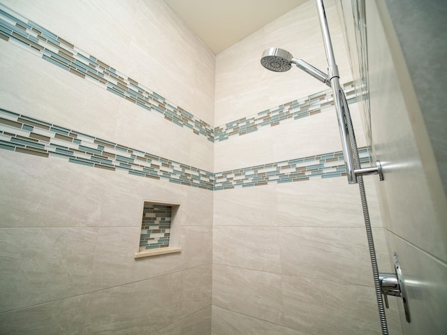 bathroom with a tile shower