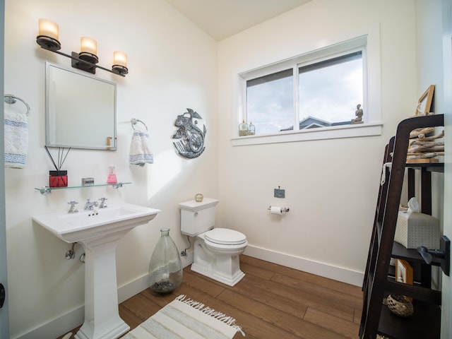 bathroom with toilet and hardwood / wood-style floors