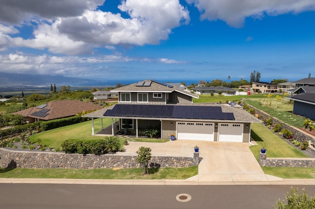 view of front of property with a garage, a front lawn, and solar panels